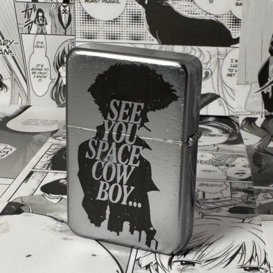 A flip lighter with an anime design, predominantly silver in color with a black and white illustration of spike spiegel from cowboy bebeop silhouetted against a city scape